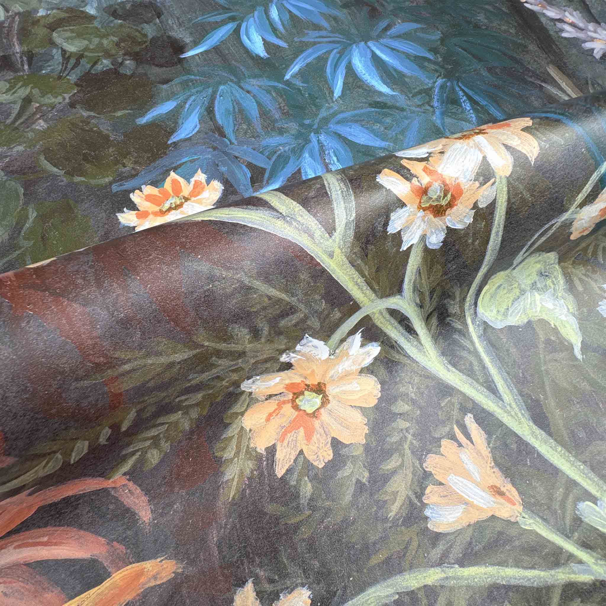 Close-up of a bespoke designer wallpaper mural featuring floral motifs in deep blues and earthy tones on premier vinyl.