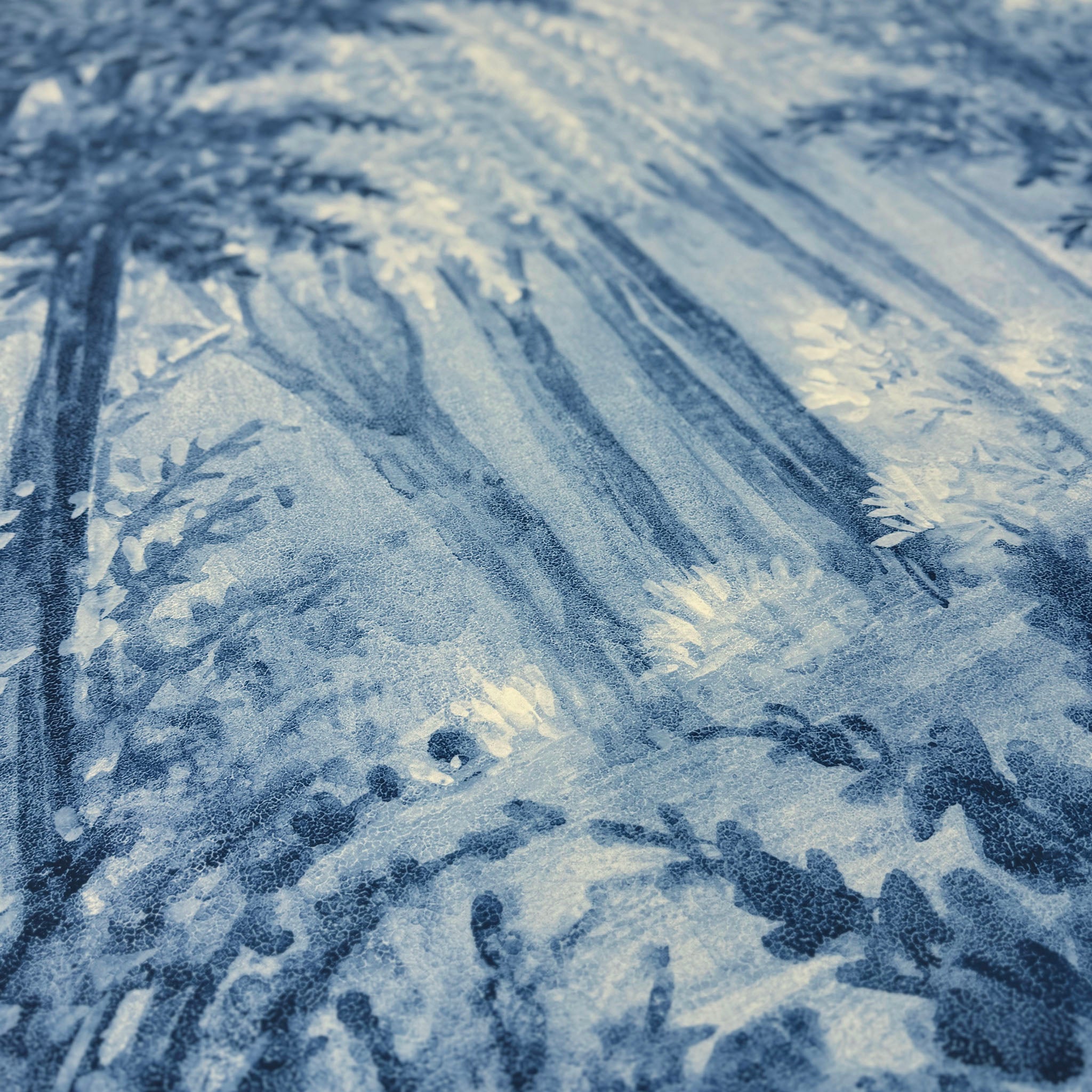 A close up view showing the detail of a matte wallpaper mural which features soft blue woodland