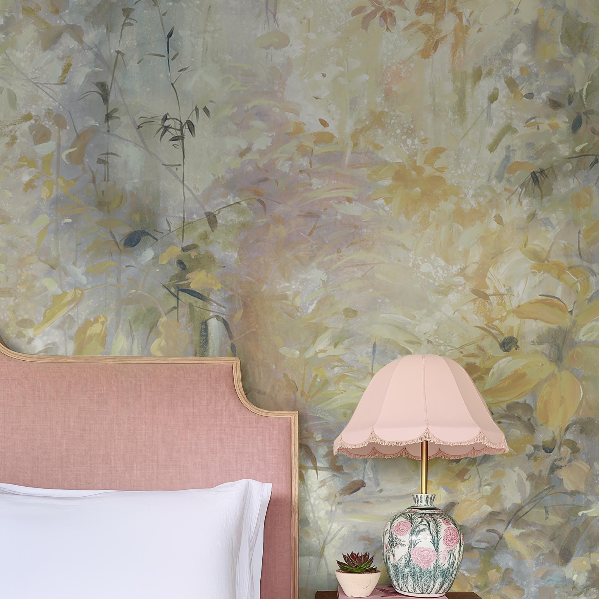 A cropped view of bedroom featuring a panoramic matte wallpaper mural of an abstract forest in lemon and cream.
