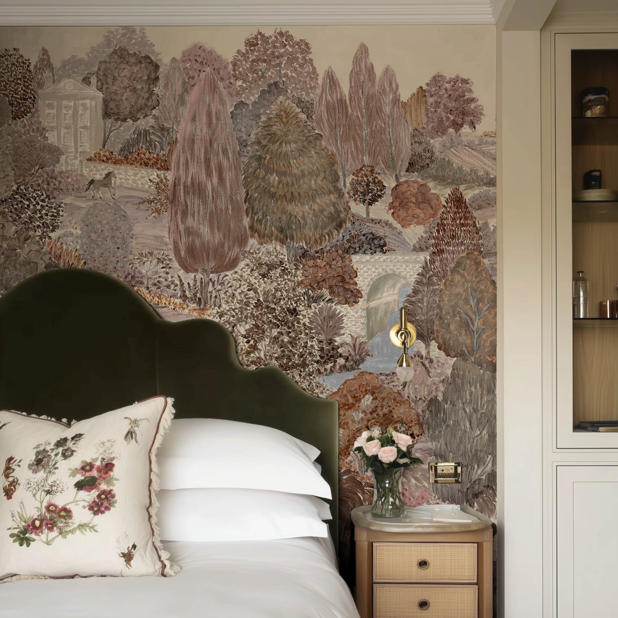 A view of a bedroom featuring a panoramic matte wallpaper mural of warm clays, soft plum, and rusted green landscape