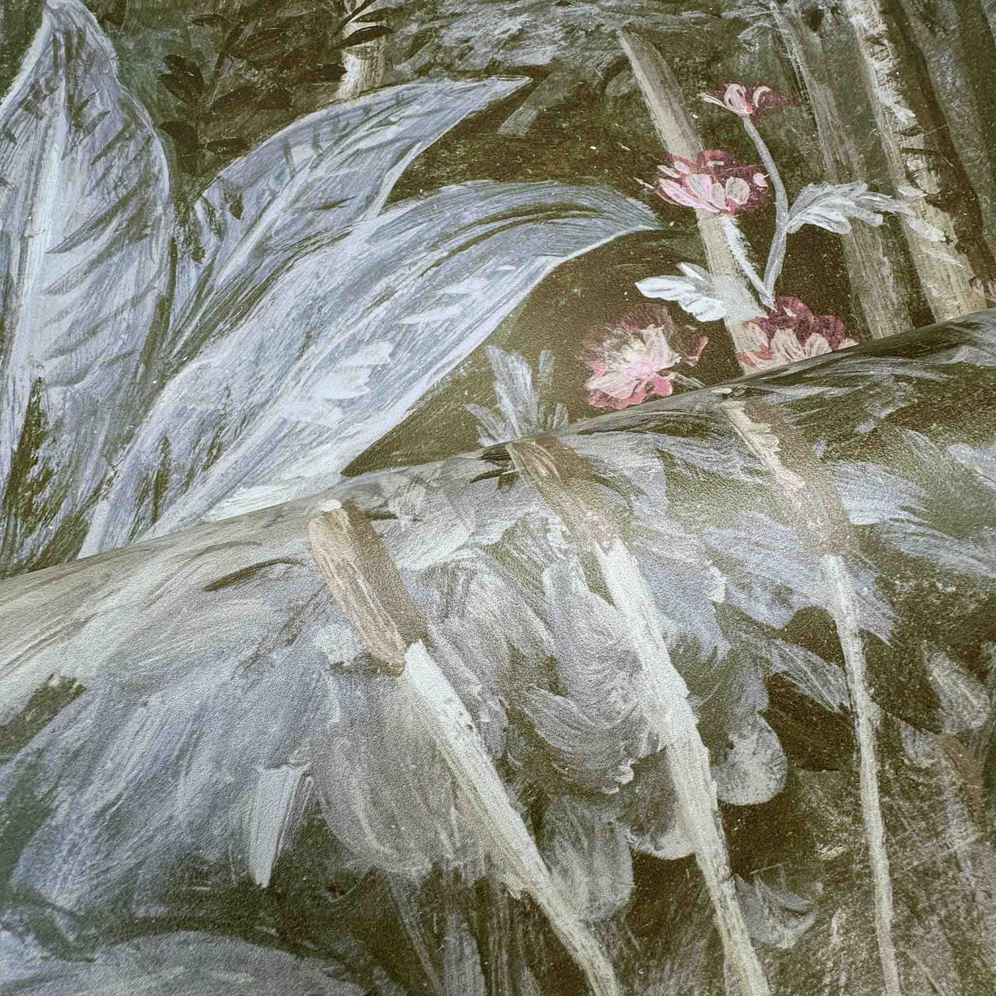 Close-up of a bespoke designer floral wallpaper mural, showcasing tropical foliage and soft ecru and grey tones.