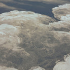 A close up view showing the detail of a matte wallpaper mural which features dramatic cream clouds