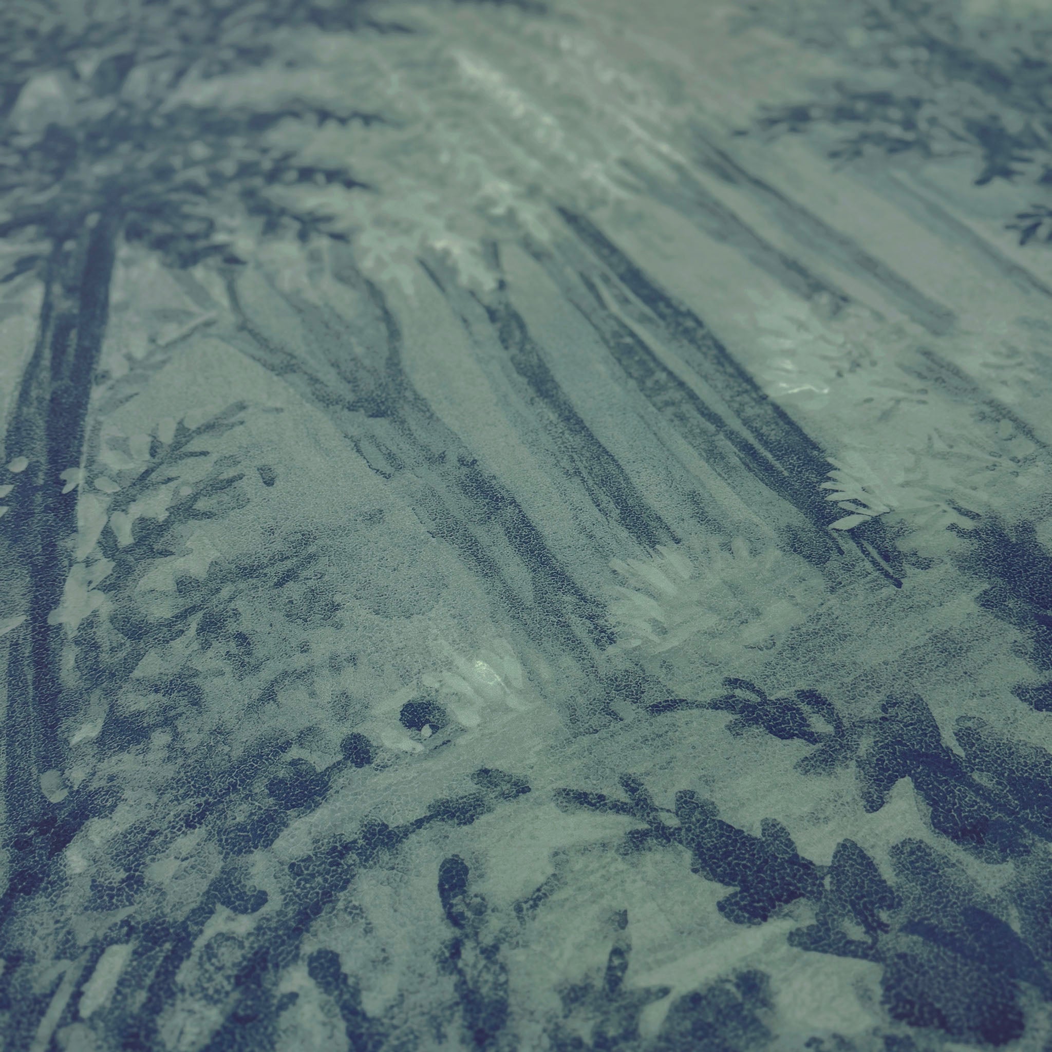 A close up view showing the detail of a matte wallpaper mural which features deep woodland