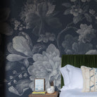 A cropped view of bedroom featuring a panoramic matte wallpaper mural of moonlit florals on deep navy