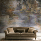 A cropped view of a living room featuring a panoramic pearlescent wallpaper mural of softly shaded panoramic mural.