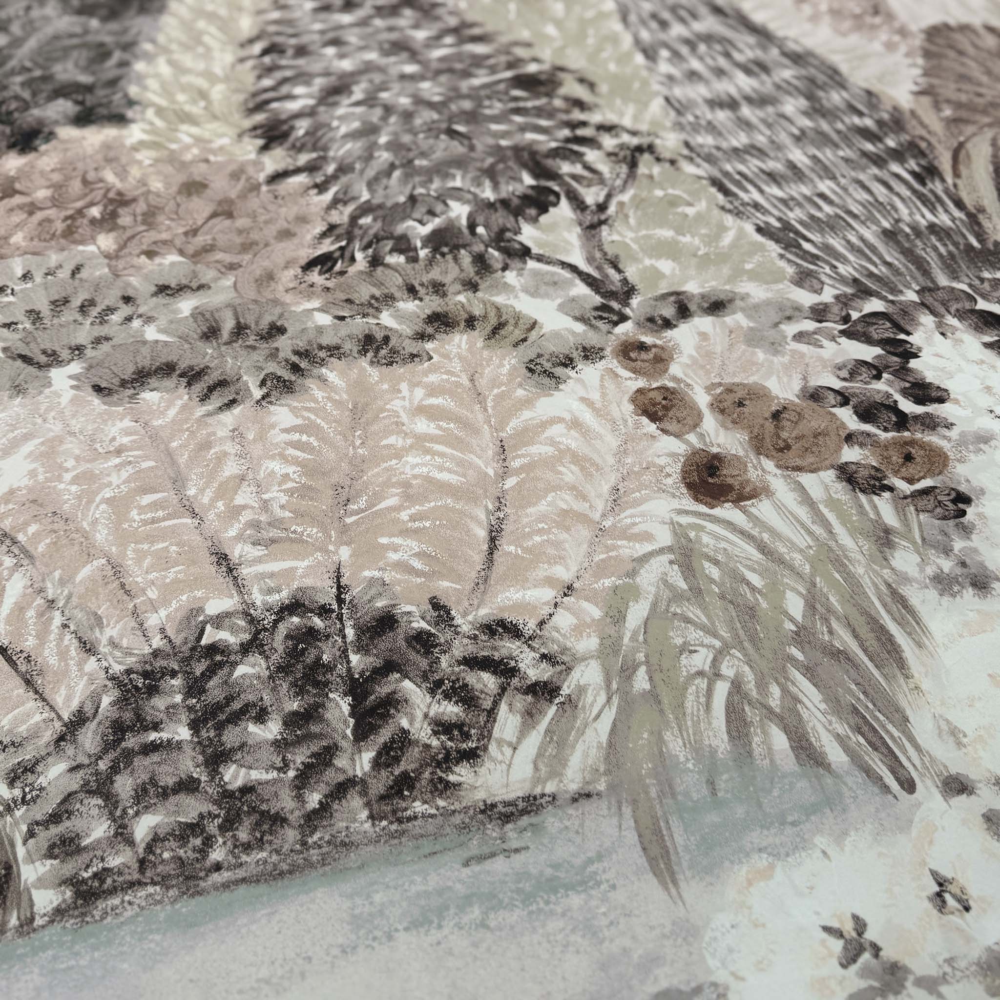 A close up view showing the detail of a matte wallpaper mural which features almond, dusty rose, and misty tones