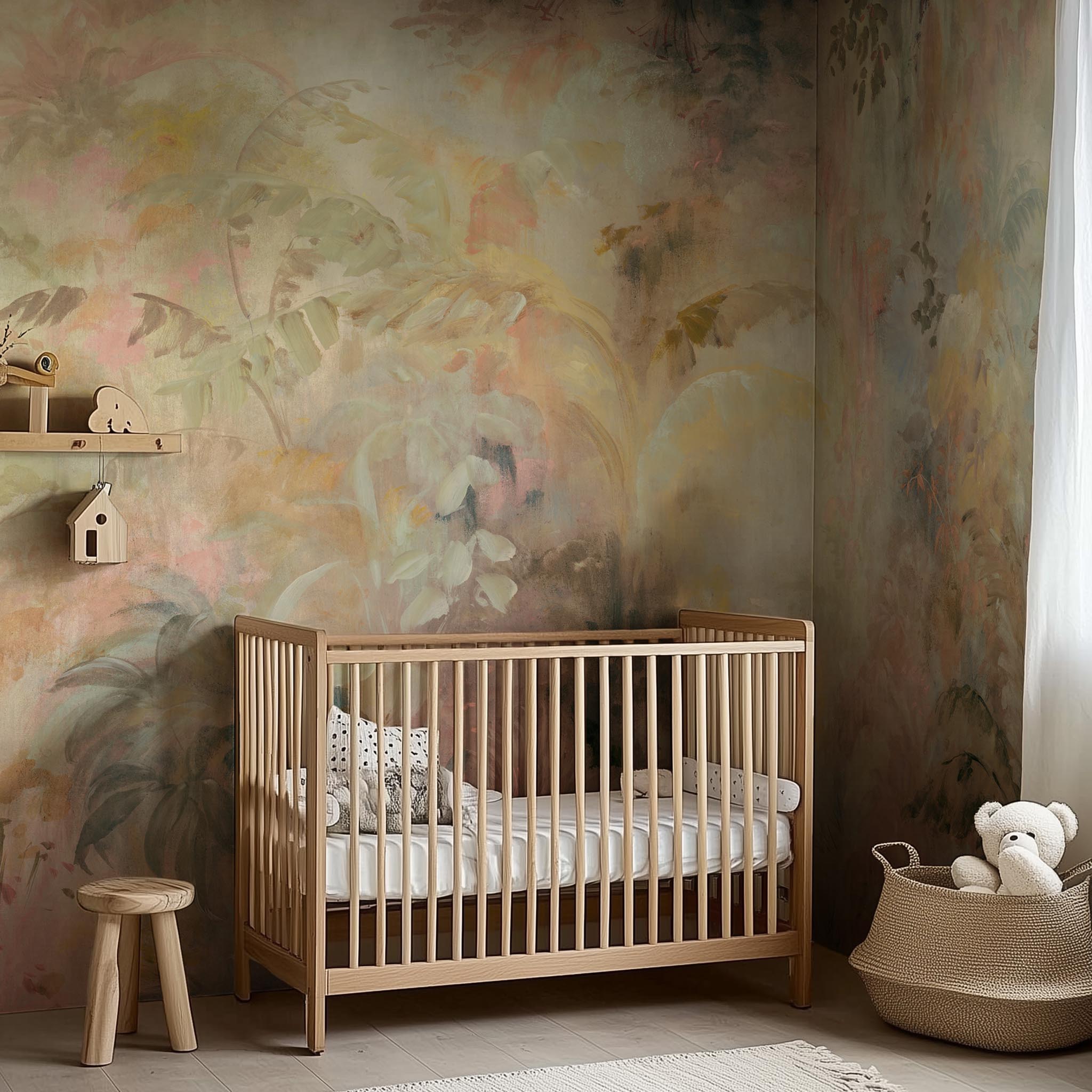 A cropped view of nursery room featuring a panoramic matte wallpaper mural of a rainforest in blush and sky blue.