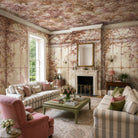 An interior living room featuring a panoramic pearlescent wallpaper mural of saffron toned mural with climbing foliage and vintage glass.