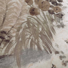 A close up view showing the detail of a grasscloth wallpaper mural which features a countryside in almond, dusty rose, and mist