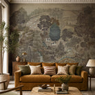 An interior living room featuring a panoramic grasscloth wallpaper mural of a countryside in deep olive, slate and ash