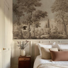A cropped view of bedroom featuring a panoramic matte wallpaper mural of sepia-toned woodland