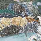 A close up view showing the detail of a matte wallpaper mural which features teal, sea green, and slate countryside scene