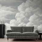 A cropped view of sitting area featuring a panoramic matte wallpaper mural of pale sculpted clouds