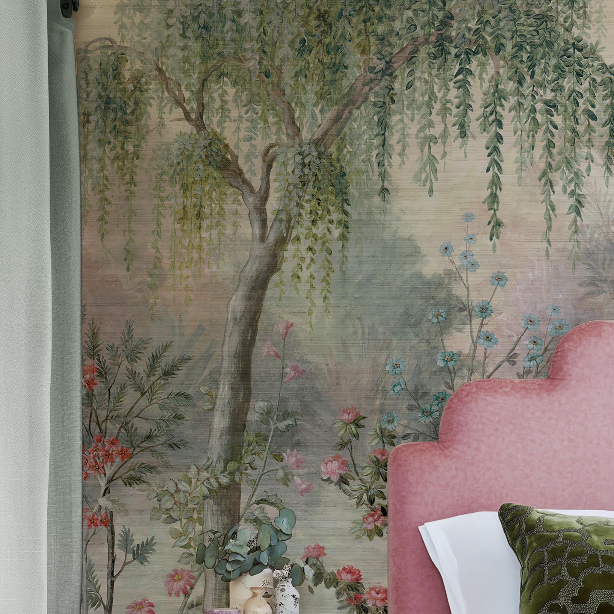 A cropped view of bedroom featuring a panoramic grasscloth wallpaper mural of a lakeside garden scene in mint and pink.