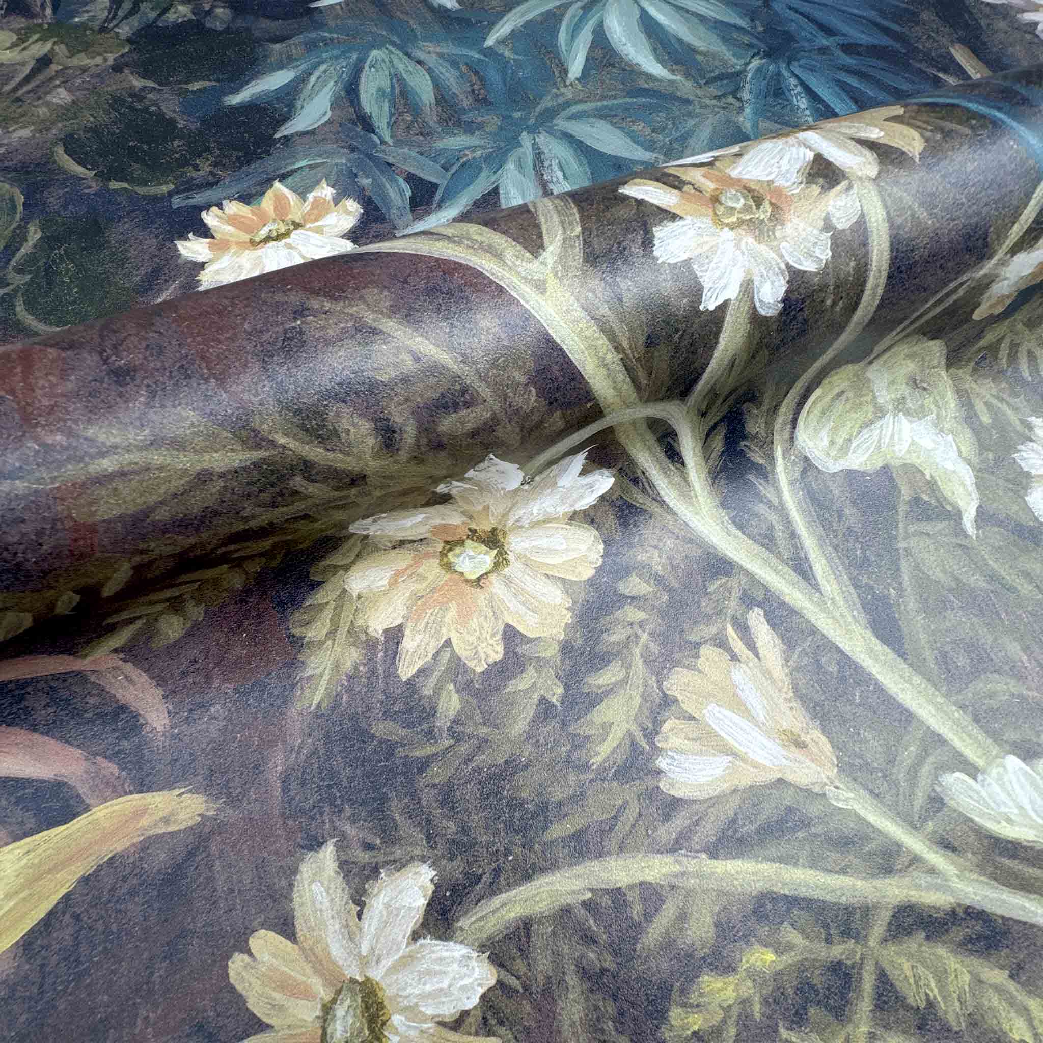 Close-up of a bespoke printed wallpaper mural featuring soft florals in lush greens and earthy tones on durable vinyl.