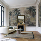 An interior living room featuring a panoramic grasscloth wallpaper mural of a tropical scene in sage and parchment.