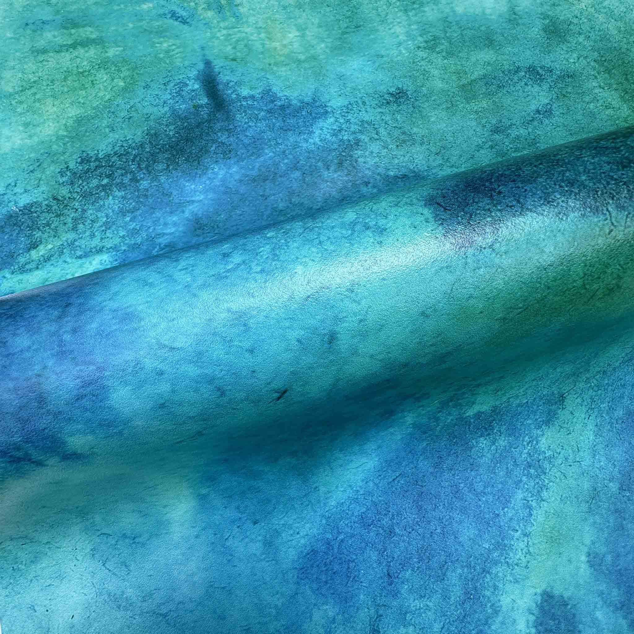 Close-up of vibrant aqua and teal abstract mural printed on durable vinyl, showcasing textured gradient patterns.