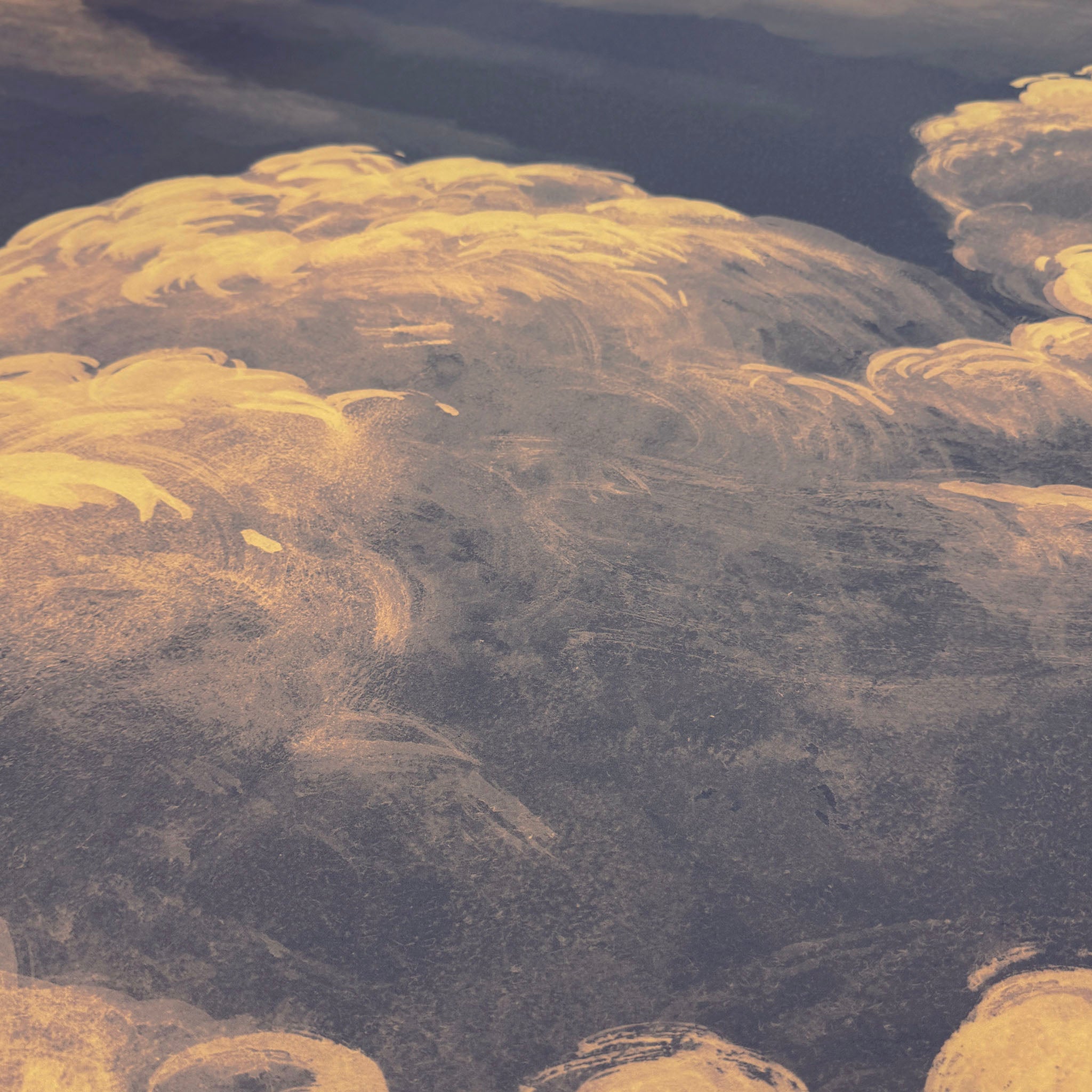 A close up view showing the detail of a matte wallpaper mural which features warm peach clouds