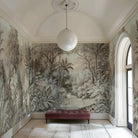 An interior sitting area featuring a panoramic vinyl wallpaper mural of a jungle vista in sepia and blush.