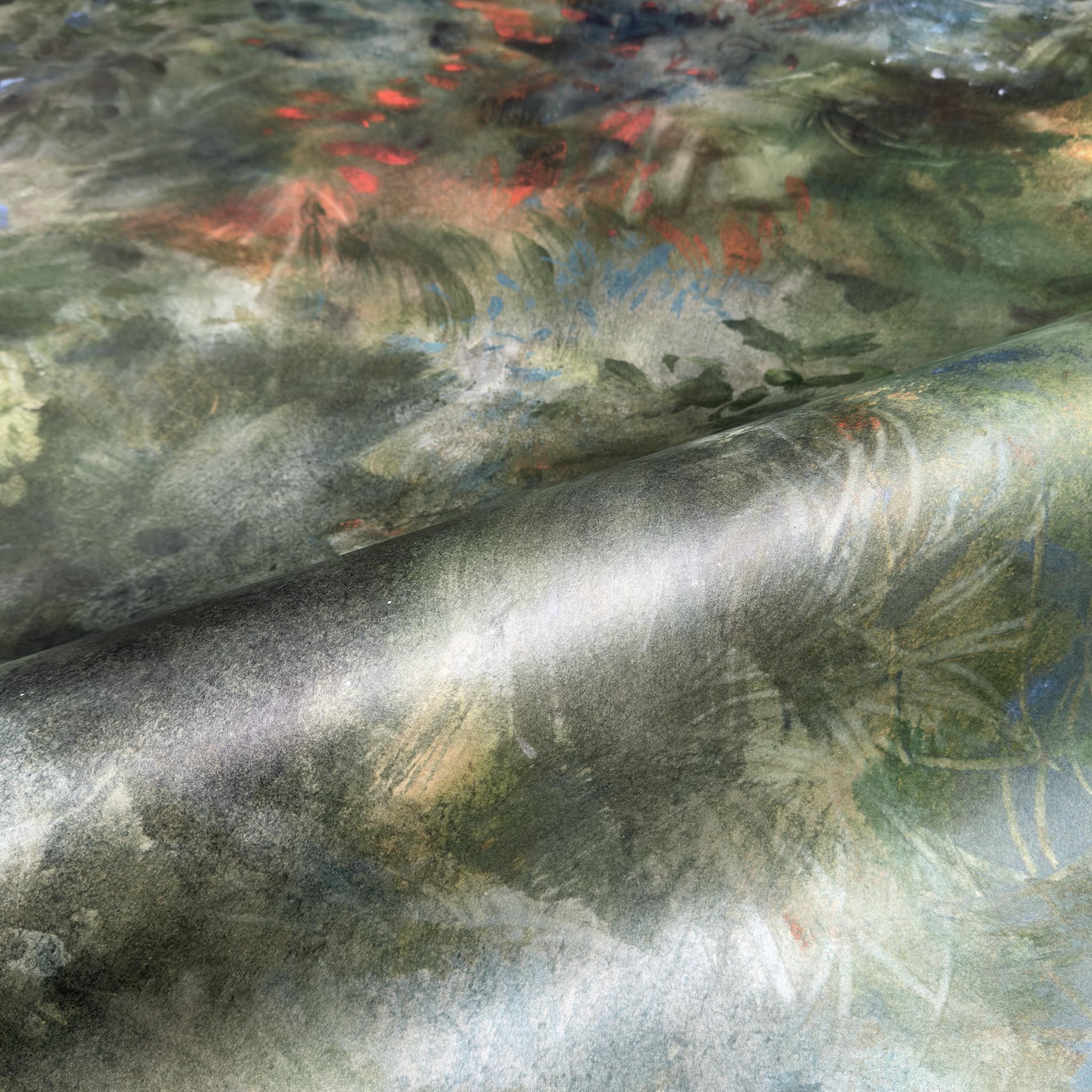 A close up view showing the detail of a pearlescent wallpaper mural which features moody nettle-green mural with sage, charcoal and rust colours.