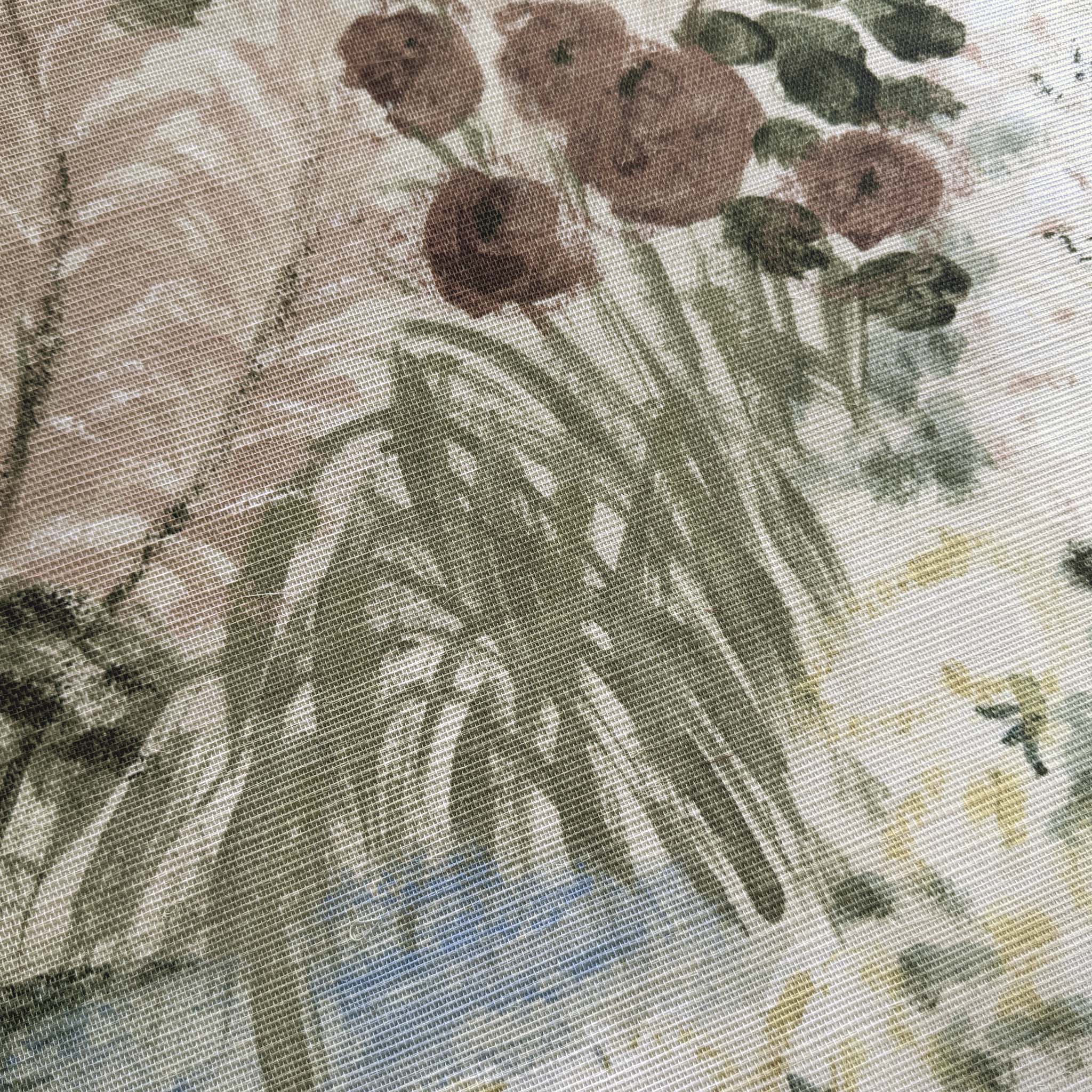 A close up view showing the detail of a grasscloth wallpaper mural which features a soft green countryside with cattle and boats
