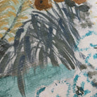 A close up view showing the detail of a grasscloth wallpaper mural which features a countryside in teal, sea green and slate