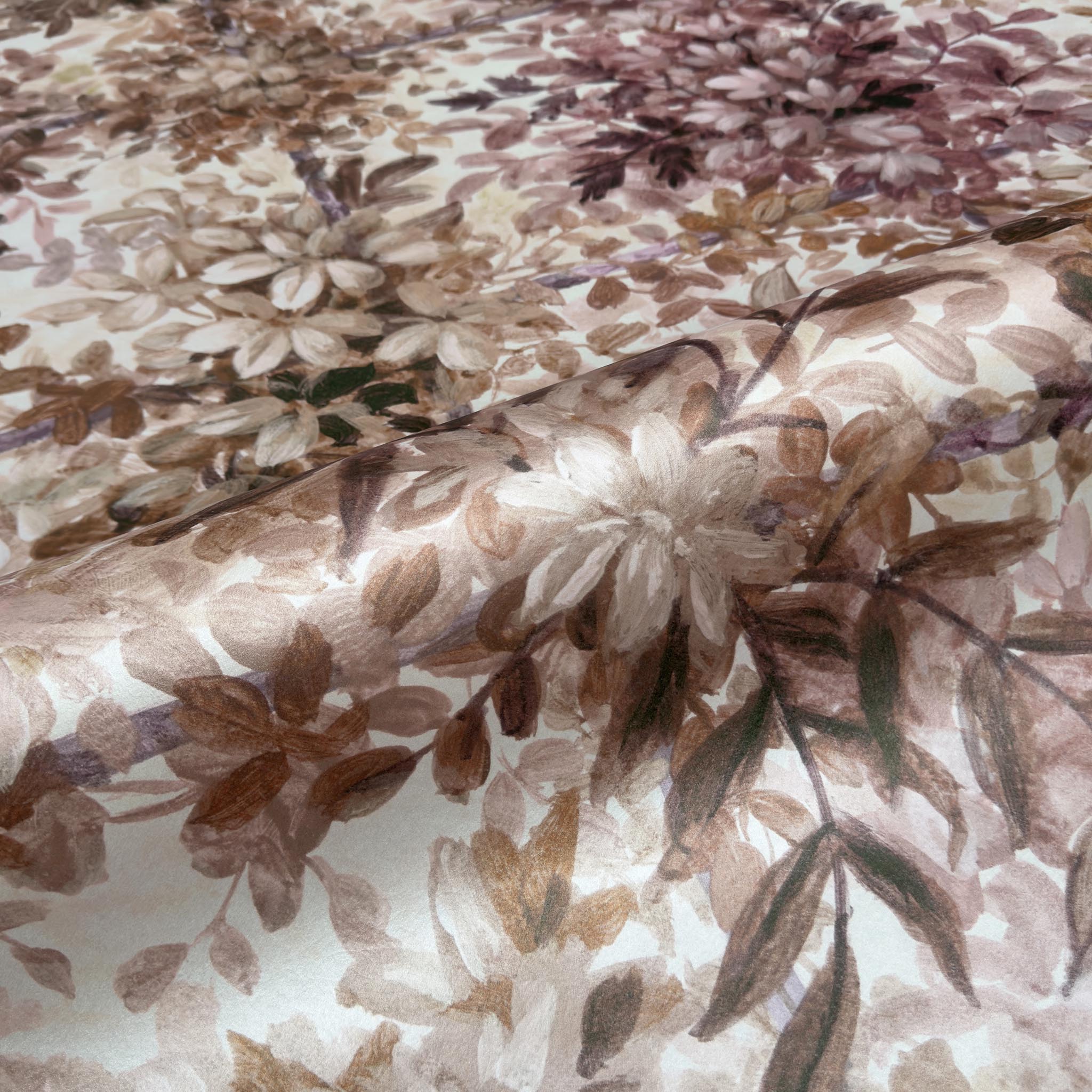 A close up view showing the detail of a pearlescent wallpaper mural which features saffron and dusky-rose mural with soft foliage.